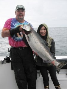 Mike Keating of Big Blue Charters and a guest fishing for salmon