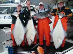 Fishermen with big halibut and salmon, on a BAMF Boat with Big Blue Charters in Sitka, Alaska.
