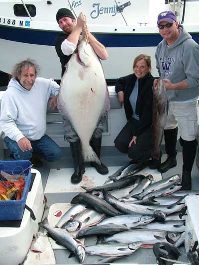 4 Big Blue Charter fishing guests with their Alaska salmon and halibut.