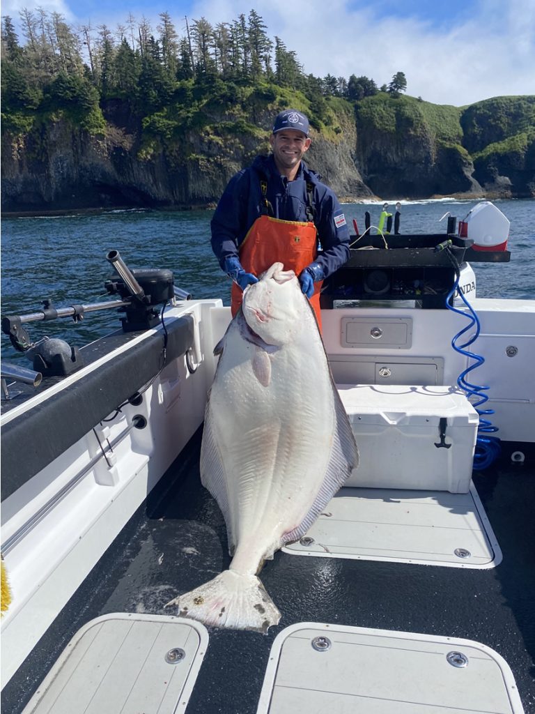 July 21, 2022 - Big Halibut with fisherman on Big Blue Charters, Alaska.